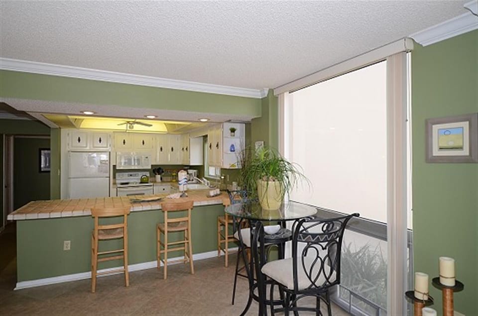 Your fully equipped kitchen flows into an inviting dining nook where you'll enjoy meals with natural light streaming through the patio doors.