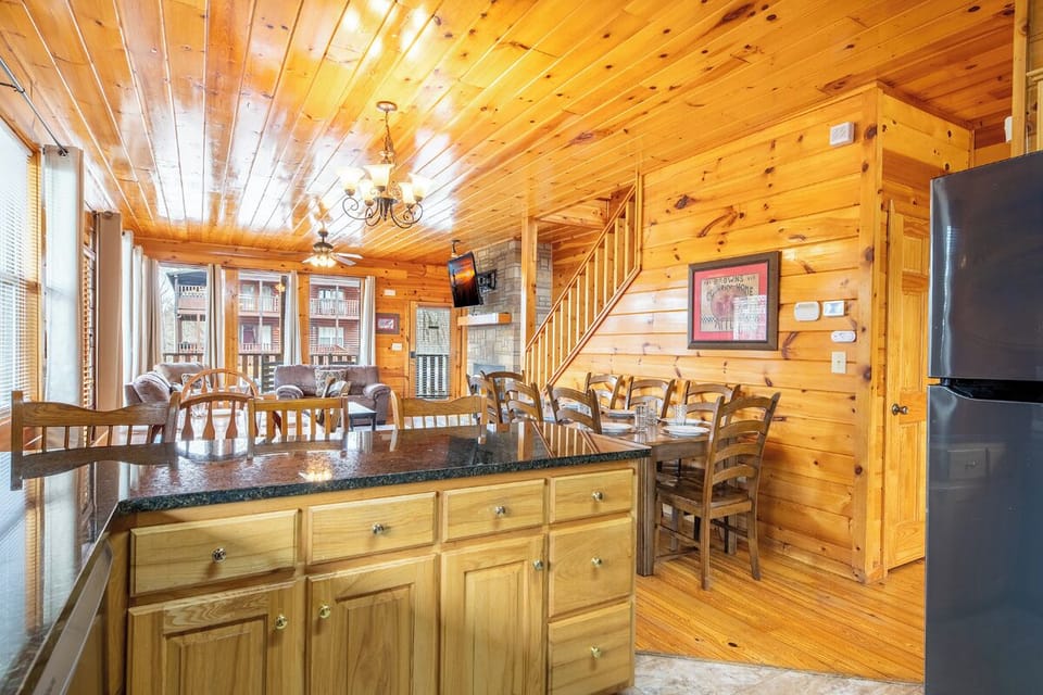 Gather around this rustic kitchen where warm wood surrounds you from floor to ceiling, creating the perfect backdrop for your mountain getaway meals.