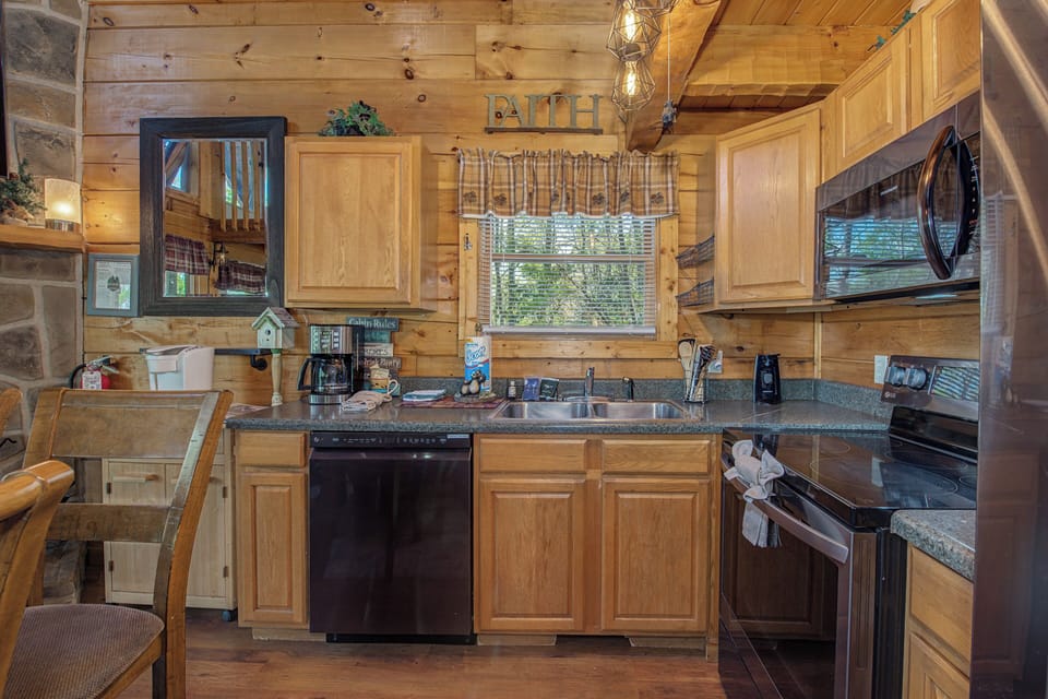 Step into your rustic kitchen with warm wood cabinets and modern appliances, perfect for preparing memorable meals during your mountain getaway.