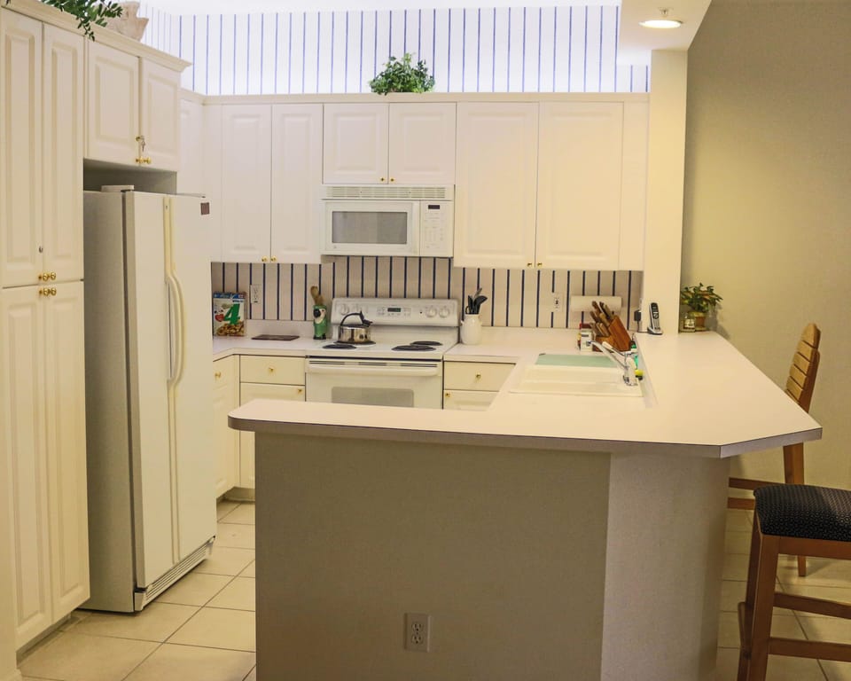 Your bright kitchen offers everything you need for homemade meals, from the full-size fridge to the breakfast bar where you can sip morning coffee.