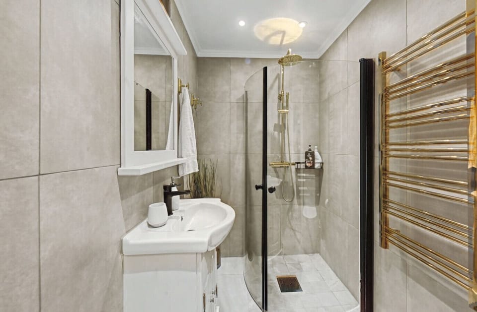 Bathroom featuring a walk-in shower and clean, modern design.
