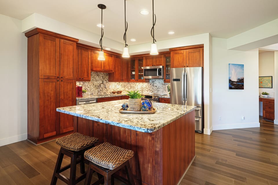 Your gourmet kitchen awaits with rich cherry cabinets, granite countertops, and stainless steel appliances—perfect for creating memorable meals together.