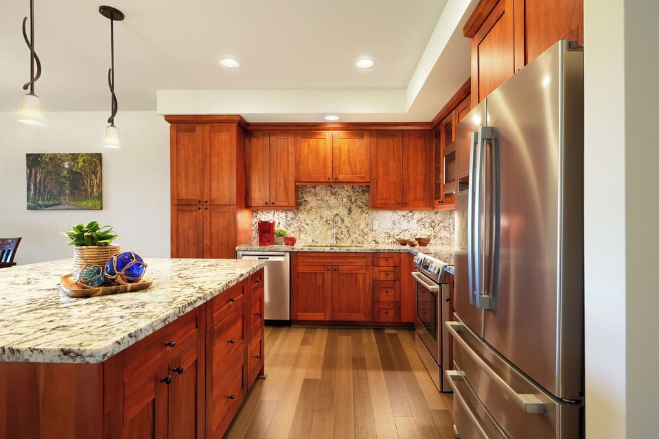Prepare your favorite meals in this beautifully appointed kitchen with rich cherry cabinets, granite countertops, and premium stainless steel appliances.