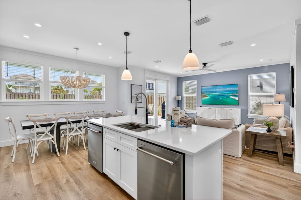 1st Floor - Expansive great room featuring living, kitchen, and dining areas with direct access to the private pool deck—perfect for large group gatherings.