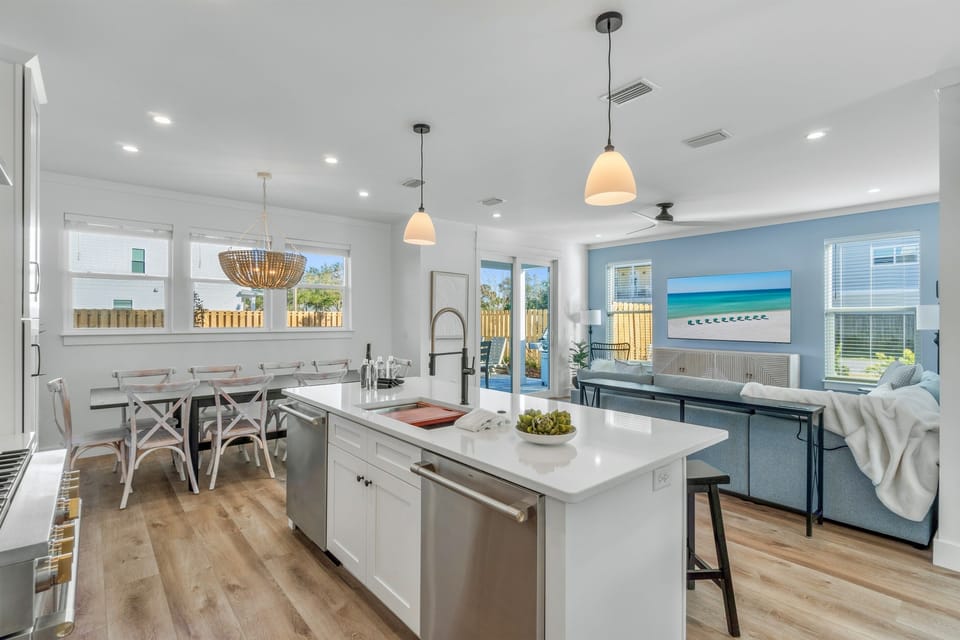 1st Floor - Expansive great room featuring living, kitchen, and dining areas with direct access to the private pool deck—perfect for large group gatherings.