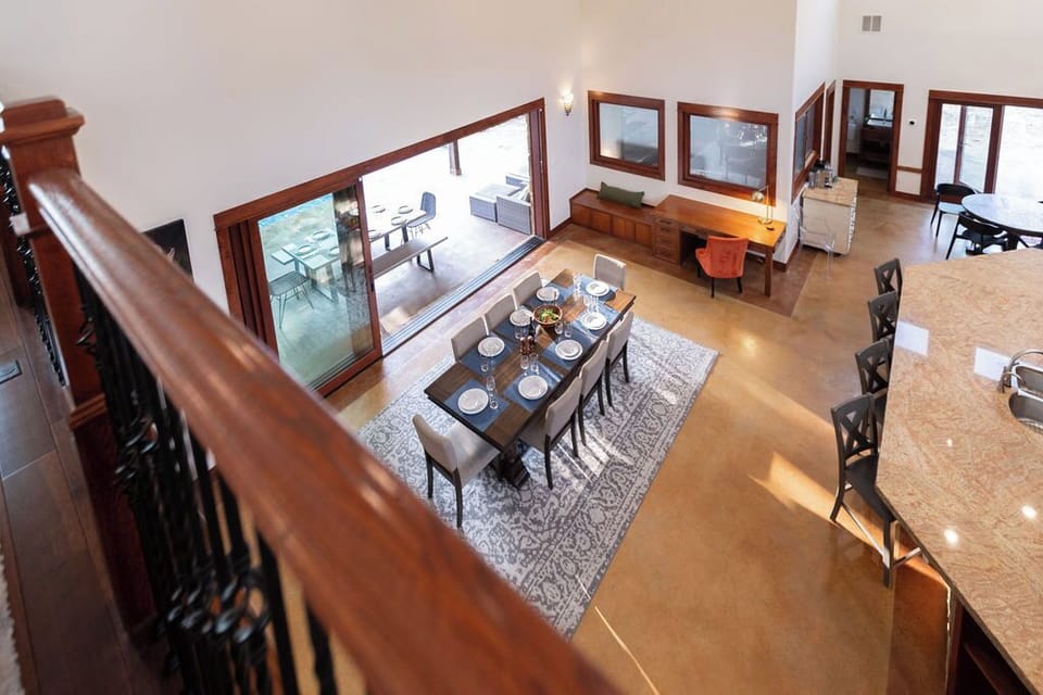 Gather around your elegant dining table for eight, where marble floors gleam beneath soaring ceilings and sliding doors open to your private terrace paradise.