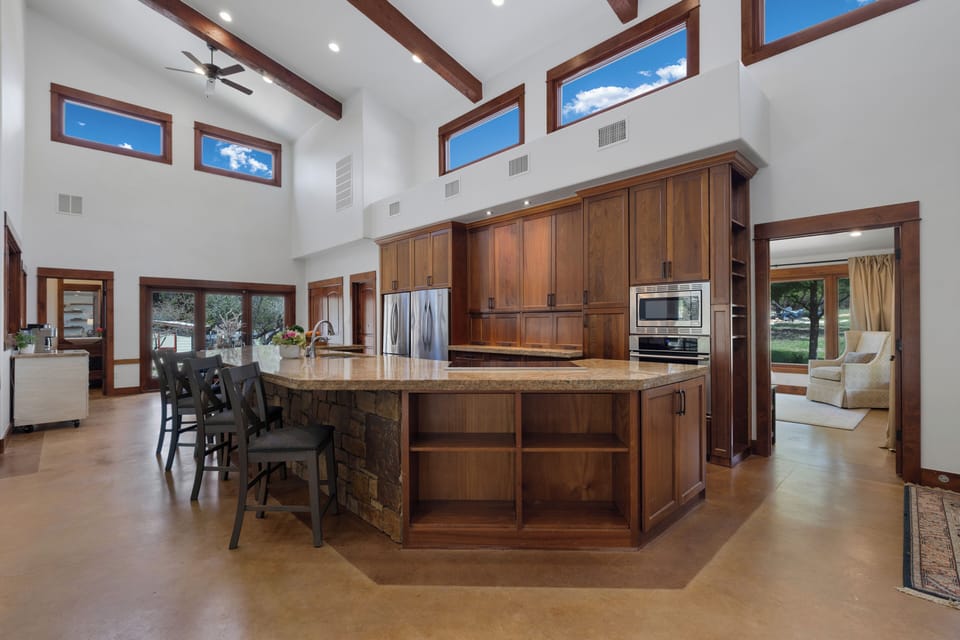 This gourmet kitchen invites you to create culinary masterpieces with premium appliances, granite countertops, and a spacious island perfect for gathering.