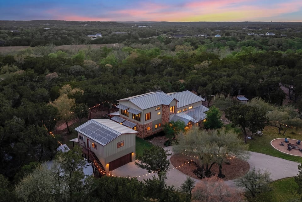 Seven-and-a-half Driftwood acres glow gold beneath a Hill Country sunset