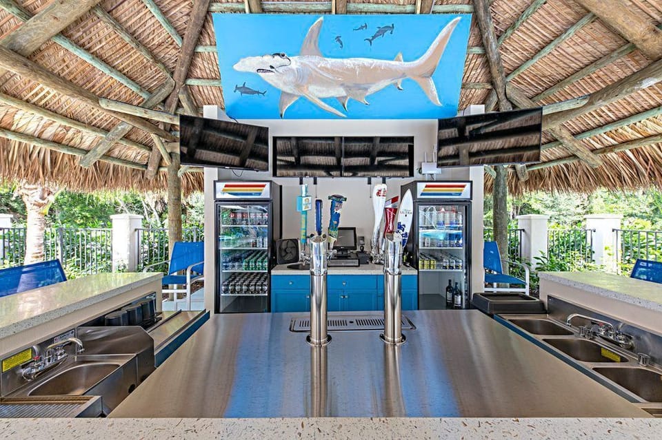 Enjoy refreshing drinks at the vibrant tiki bar, perfectly designed for relaxation under the sun.