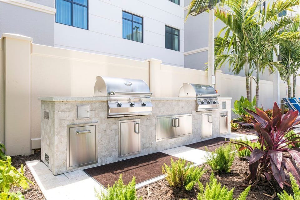 Grill up a feast in style at these sleek outdoor BBQ stations, nestled amidst tropical landscaping.