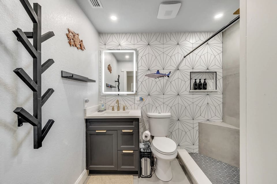 Modern bathroom with geometric tile accents and a walk-in shower