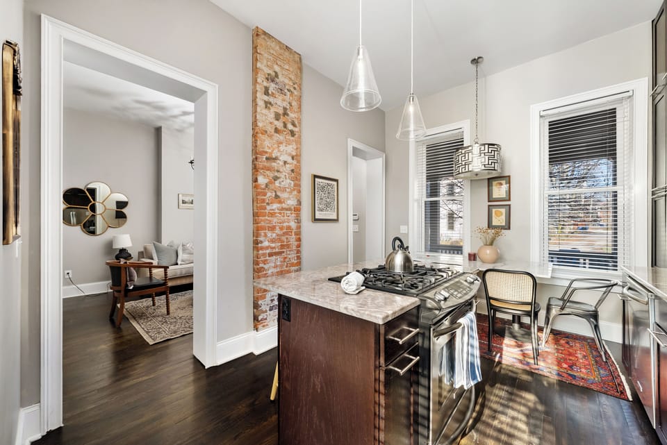 Open kitchen view with exposed brick detail.