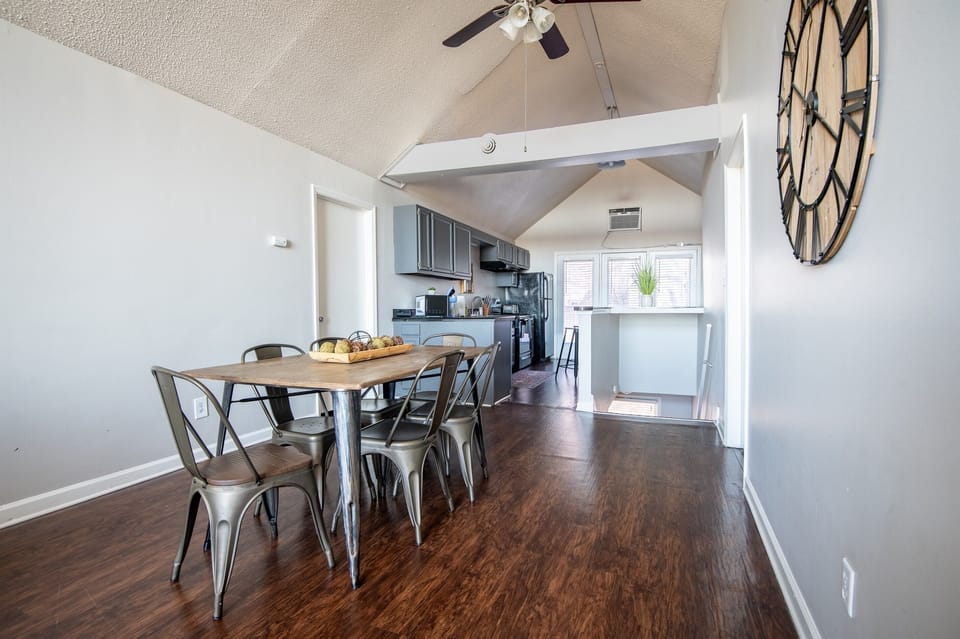 This view of the dining area shows the entry staircase and kitchen so that you can see just how much space there is in Unit G!