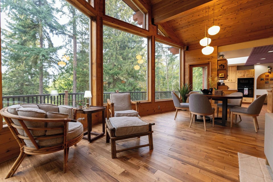 Relax with panoramic forest views in this bright, open-living space.
