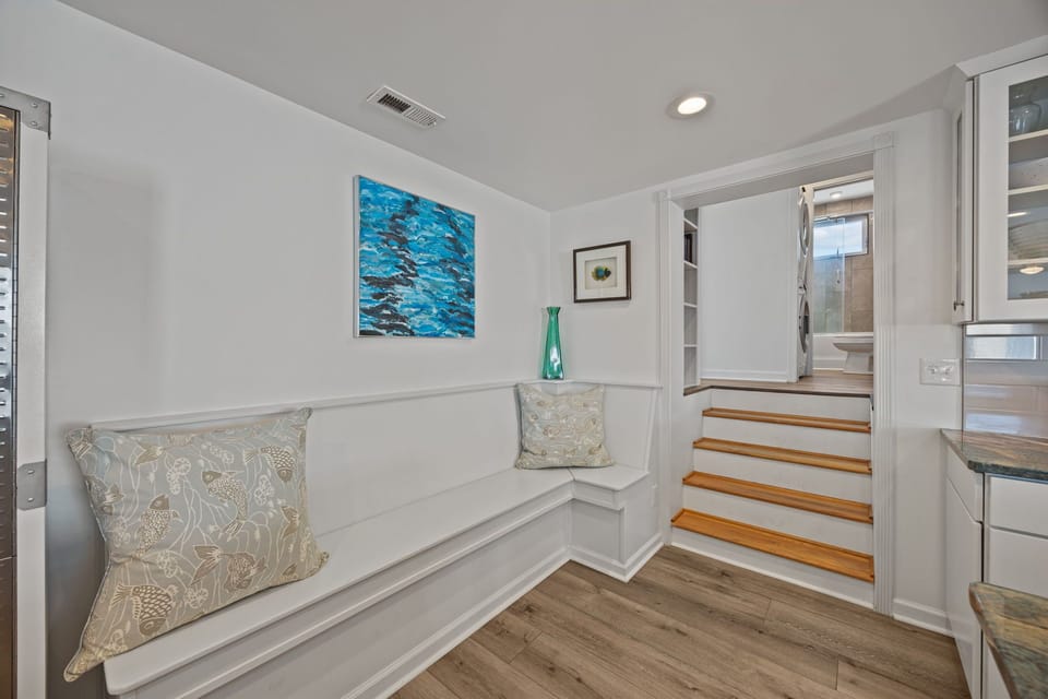 Cozy built-in bench with coastal art and soft seating