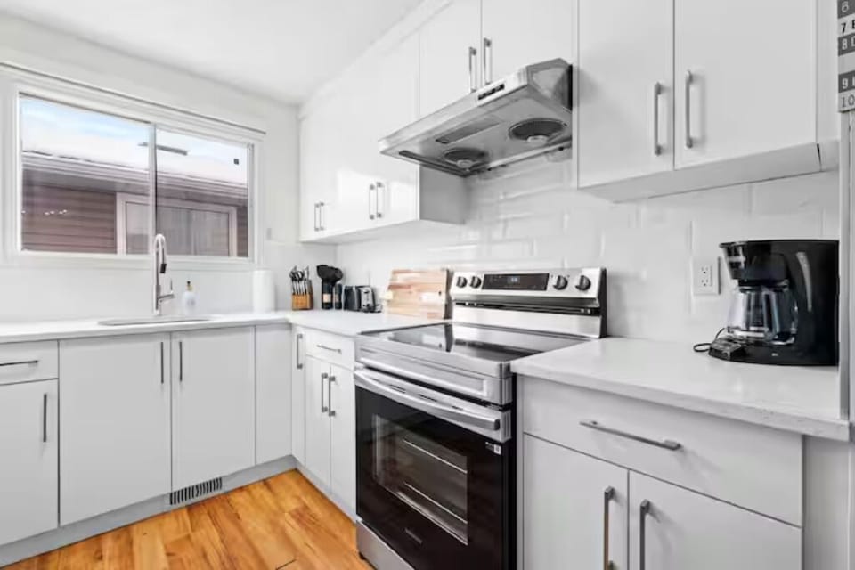 Fully equipped modern kitchen with stainless steel appliances & coffee make