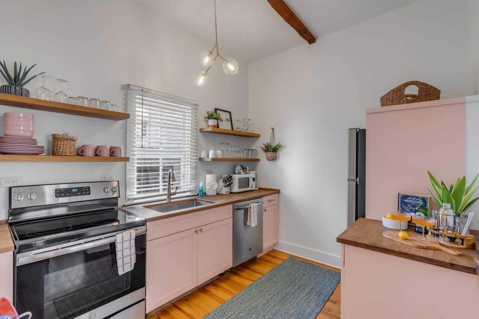 A fully stocked kitchen with modern appliances, cookware, dishes, and coffee maker for meals at home.