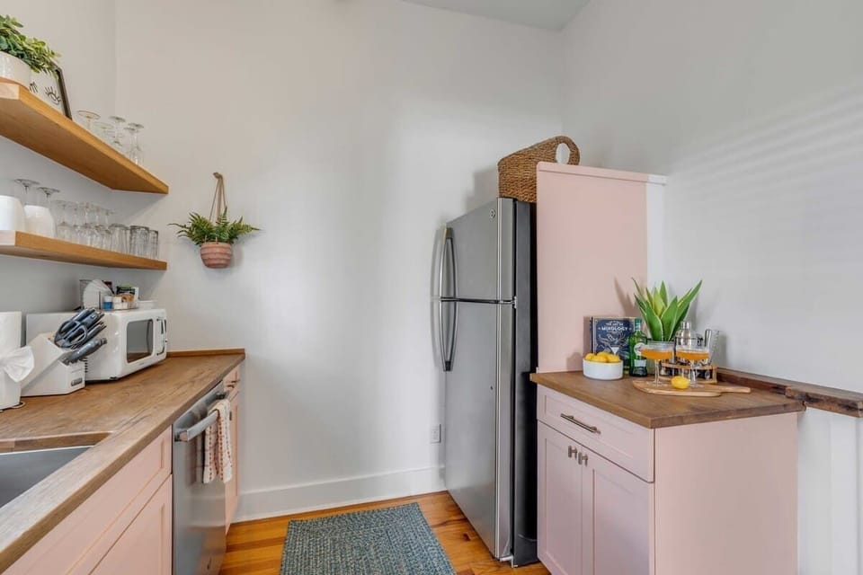 A fully stocked kitchen with modern appliances, cookware, dishes, and coffee maker for meals at home.