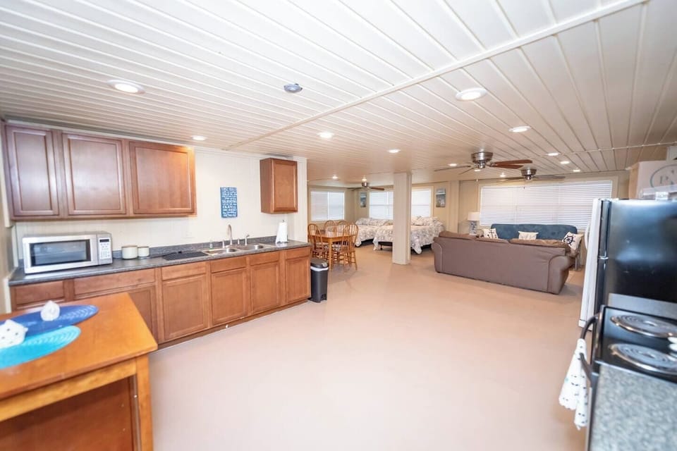 Downstairs full kitchen area opens up to living ang dining area.