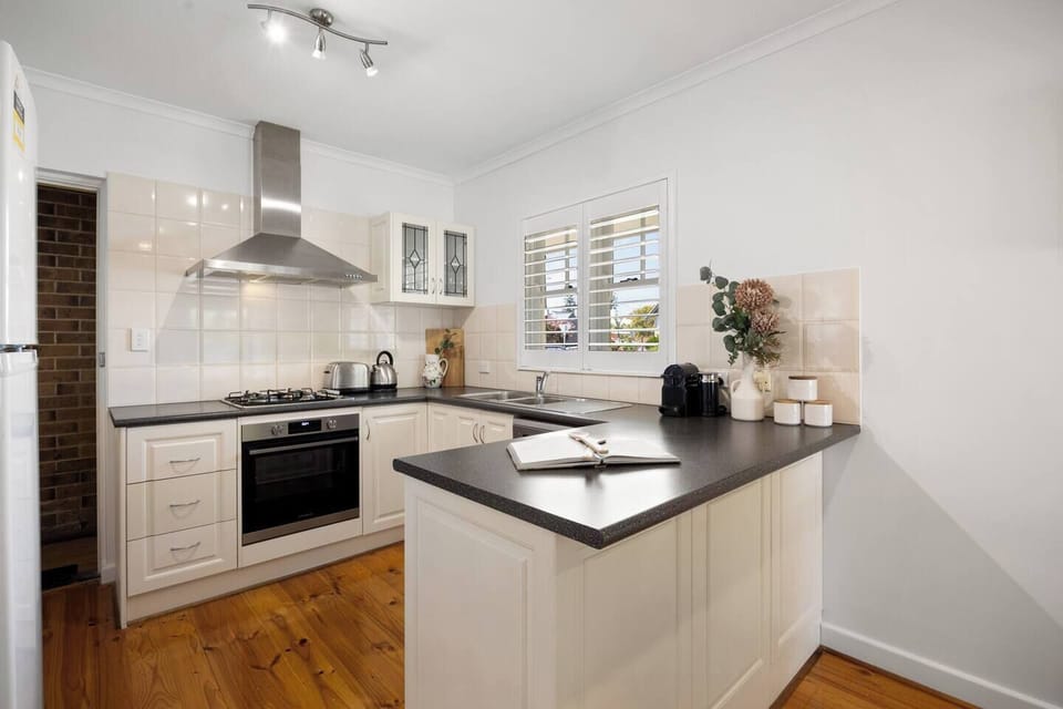Prepare meals with ease in the full kitchen, featuring a gas cooktop, oven, microwave, dishwasher, full-sized fridge, plus a Nespresso machine for your morning rituals.