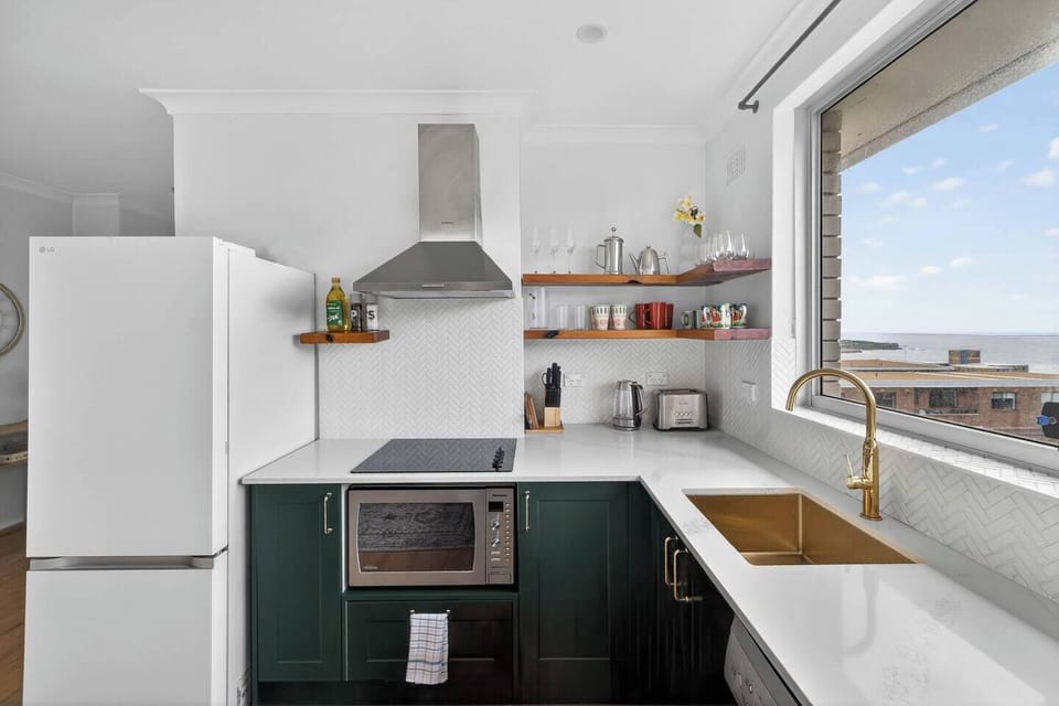 Cook with ease in the well-equipped kitchen, complete with oven, stove, microwave, dishwasher and full-size fridge for effortless meals at home.