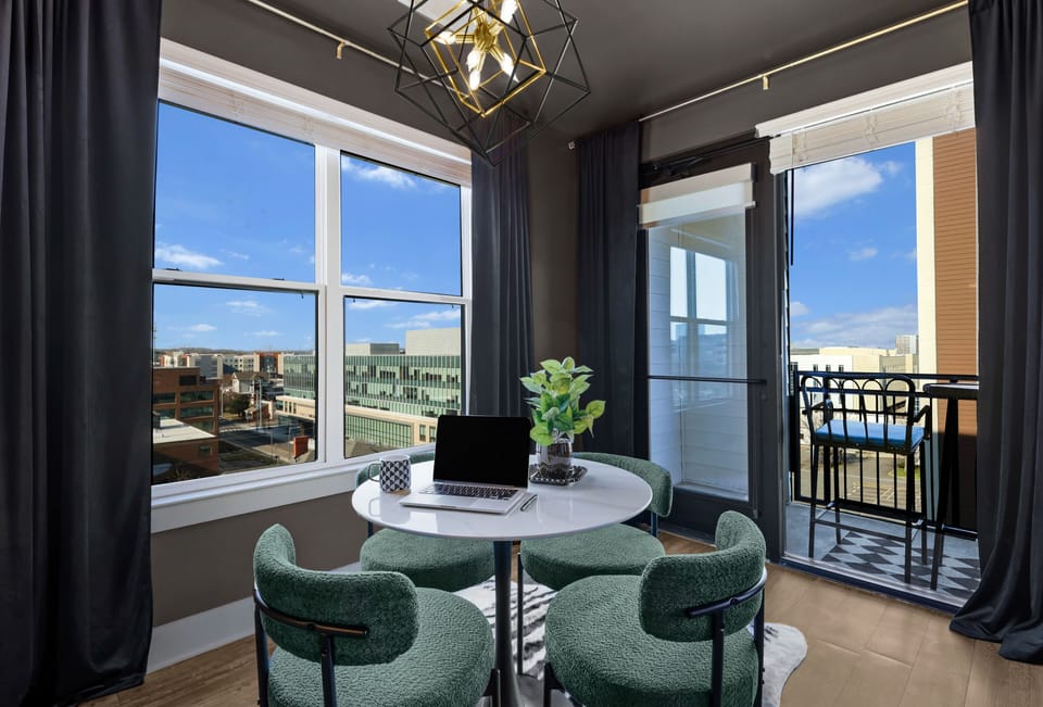 ✦ Dining Nook ✦ Gold chandelier, plush emerald chairs & city views for days.