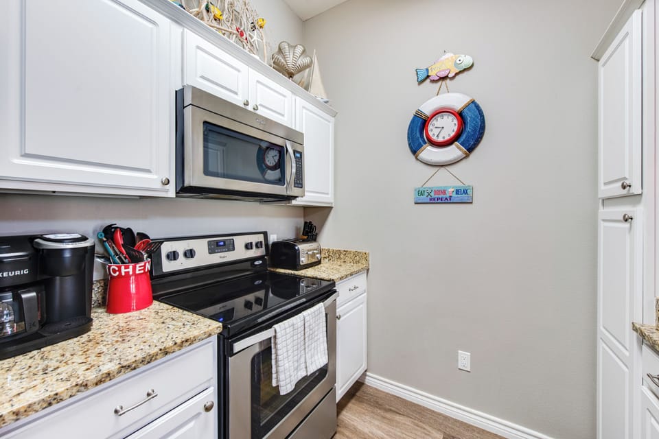 Your fully equipped kitchen features granite counters, stainless appliances, and charming coastal décor for memorable vacation cooking.