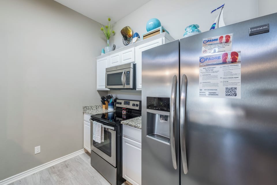 Step into your bright, open kitchen where granite counters and modern appliances await your culinary adventures.