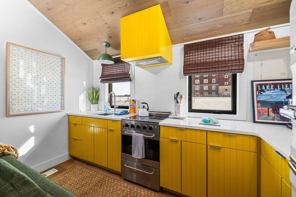 Modern kitchen with bold design and lake views 🍳🌅

This fully equipped kitchen features striking yellow cabinetry, sleek stainless steel appliances, and plenty of counter space for cooking and entertaining.