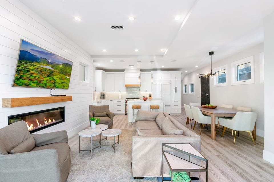 A stunning view of the open-concept layout showcasing the integrated dining area and high-end finishes. The clean architectural lines and contemporary decor provide a versatile space for both entertaining and daily living.