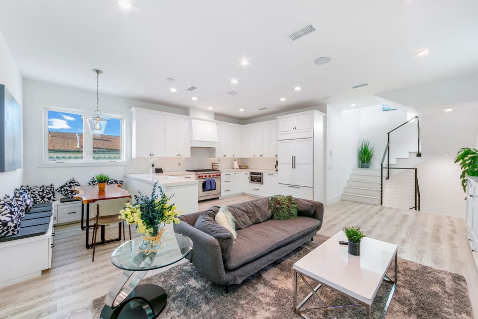 This final perspective of the main floor showcases the home's ability to host guests comfortably, with ample seating and easy access to all main-level amenities.