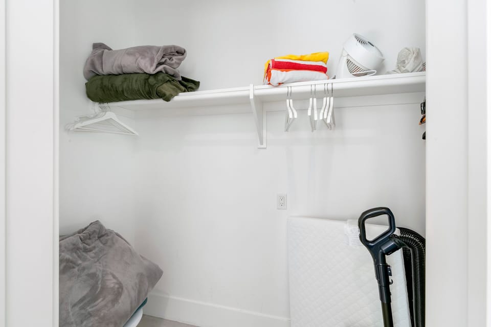 Generous closet space with shelving and storage—ideal for luggage and extended stays.