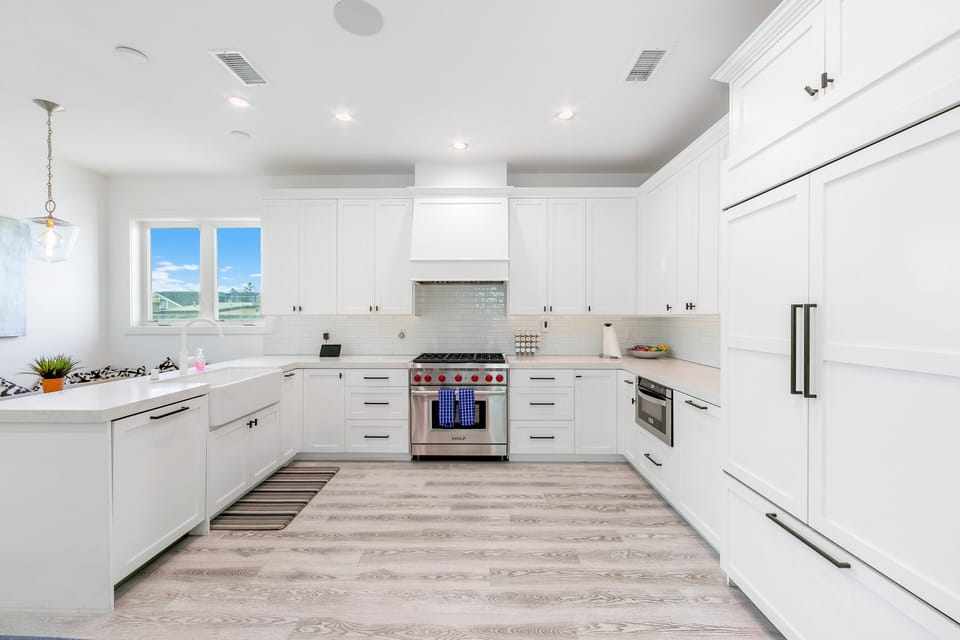 Spacious chef's kitchen with custom cabinetry, high-end stainless steel appliances, and generous prep space for entertaining.