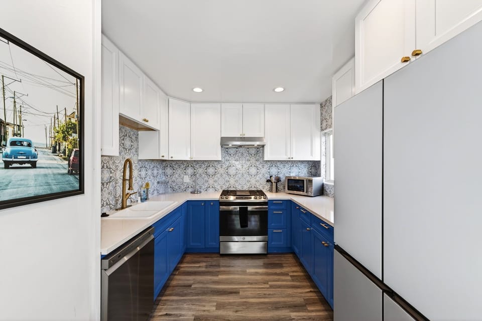 Prepare meals with ease in the fully-equipped kitchen featuring brand-new appliances, ample counter space, and a bright, functional layout ideal for beachside dining and entertaining.