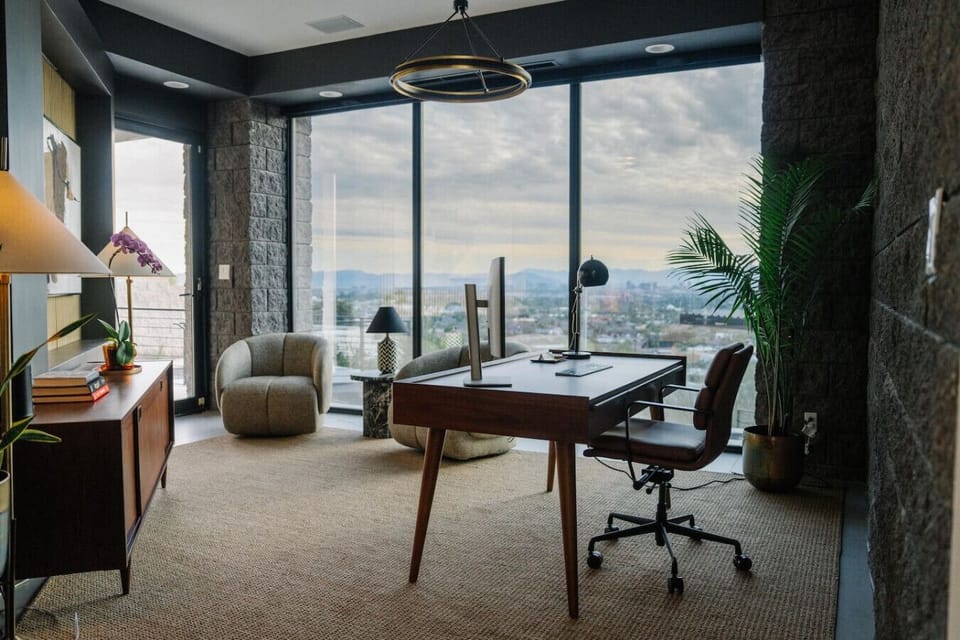 Modern office space with panoramic city views and floor-to-ceiling windows.