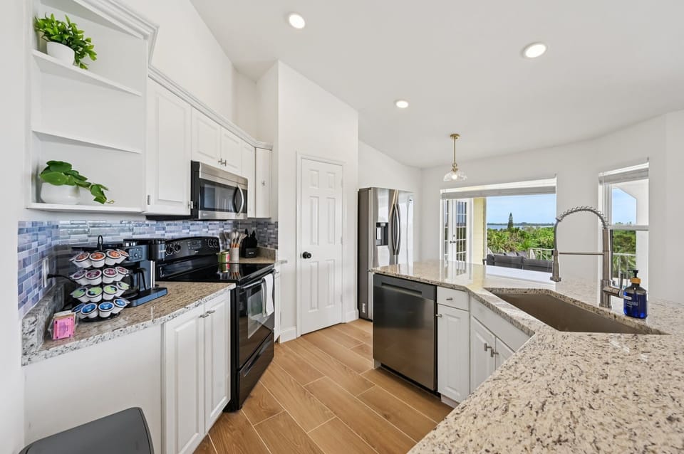 Well-equipped kitchen with spacious counters and river views.