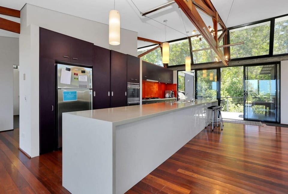 Fully equipped kitchen with a full size fridge and a breakfast bar.