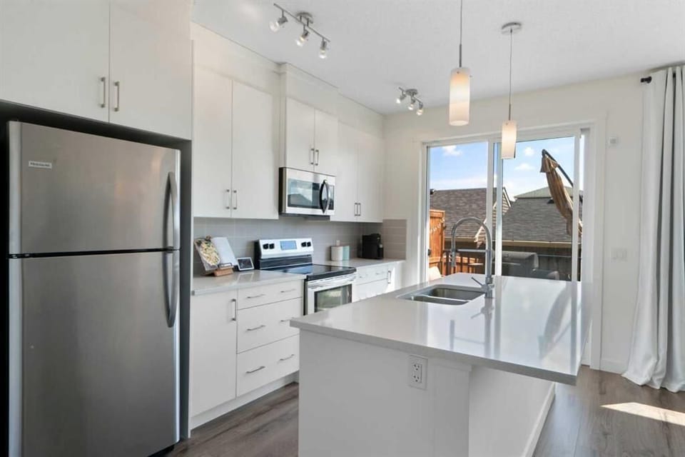Modern kitchen with stainless steel appliances, ample counter space for cooking