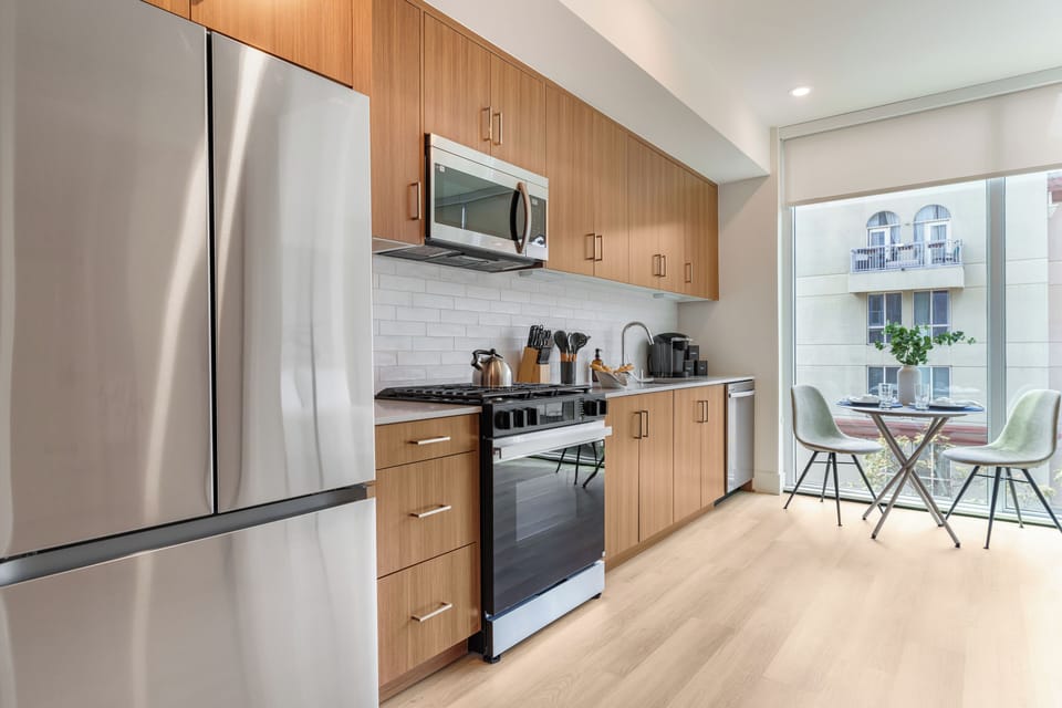 Cook in style with sleek quartz countertops, modern cabinetry, and stainless steel appliances.