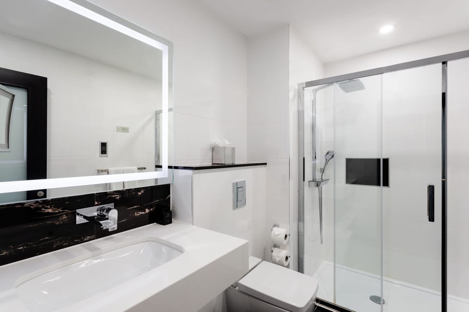 Designer toiletries, hair dryer, slippers, towels