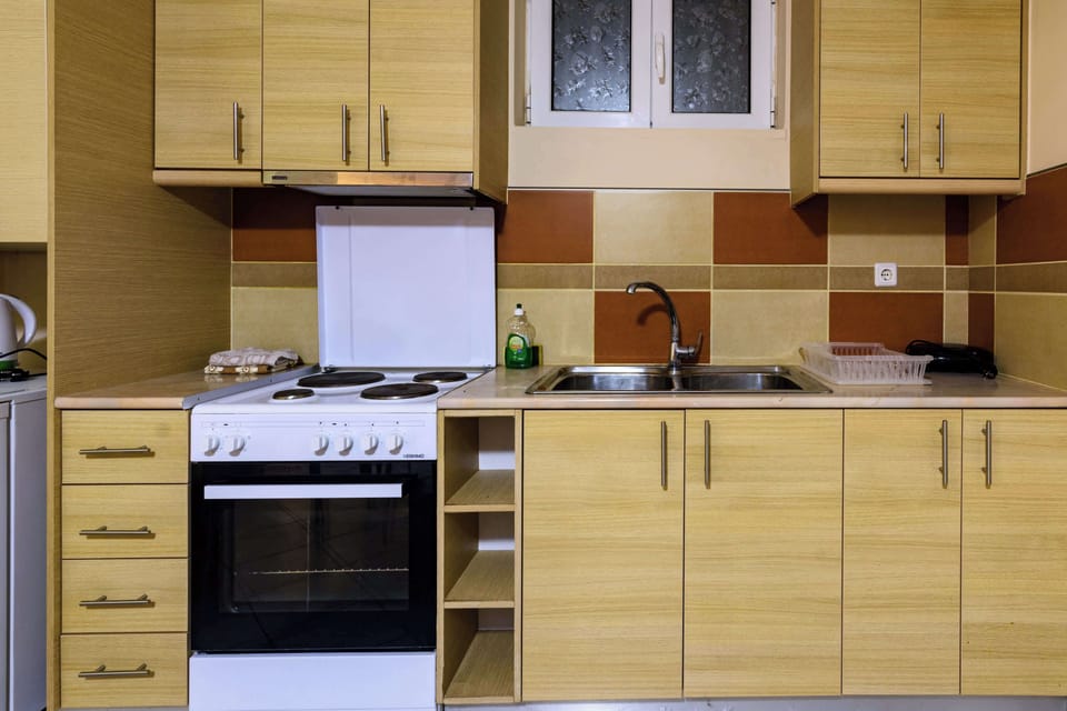 Fully Equipped Kitchen with Oven and Storage Cabinets