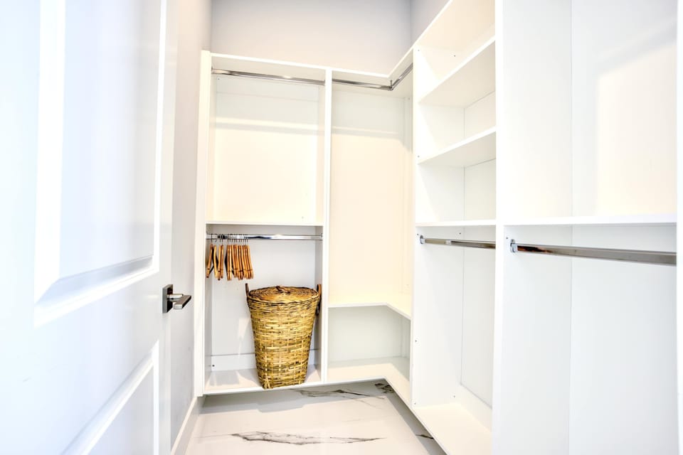 Spacious Walk-In Closet With Plenty Of Storage Space; Shelving And Hanging Areas; Perfect For Organizing All Your Belongings.