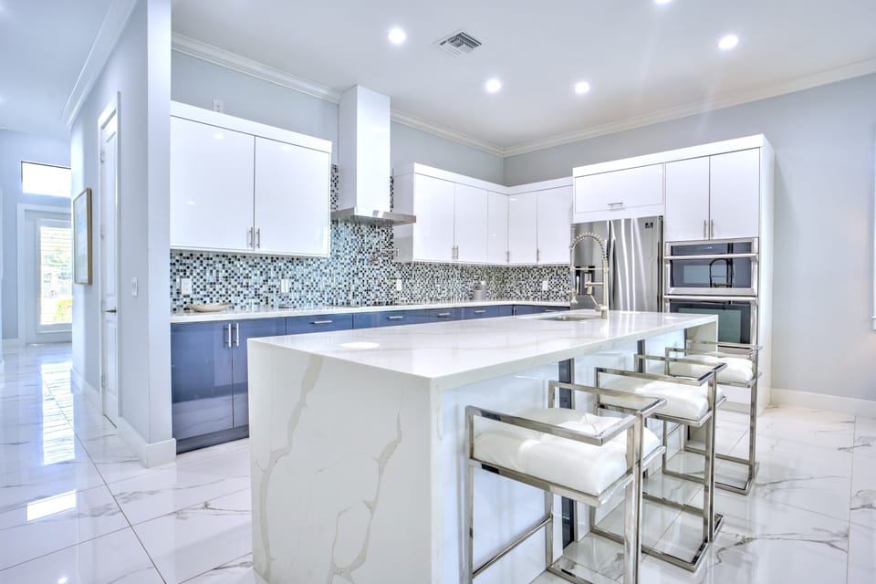 Kitchen With All Necessary Appliances; Central Island With High Bar Stools; Plenty Of Space For Cooking And Gathering