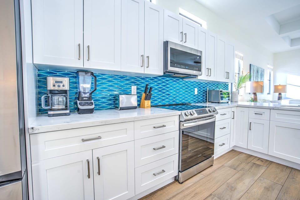 This home away from home is stocked with all the appliances you'll need. See a coffee maker, ninja blender, toaster, and even toaster oven!