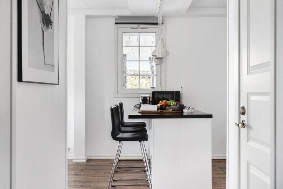 Spacious family kitchen with island seating and modern appliances, perfect for cooking and gathering together.