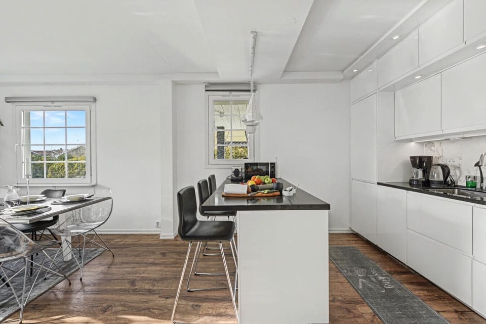 Spacious family kitchen with island seating and modern appliances, perfect for cooking and gathering together.