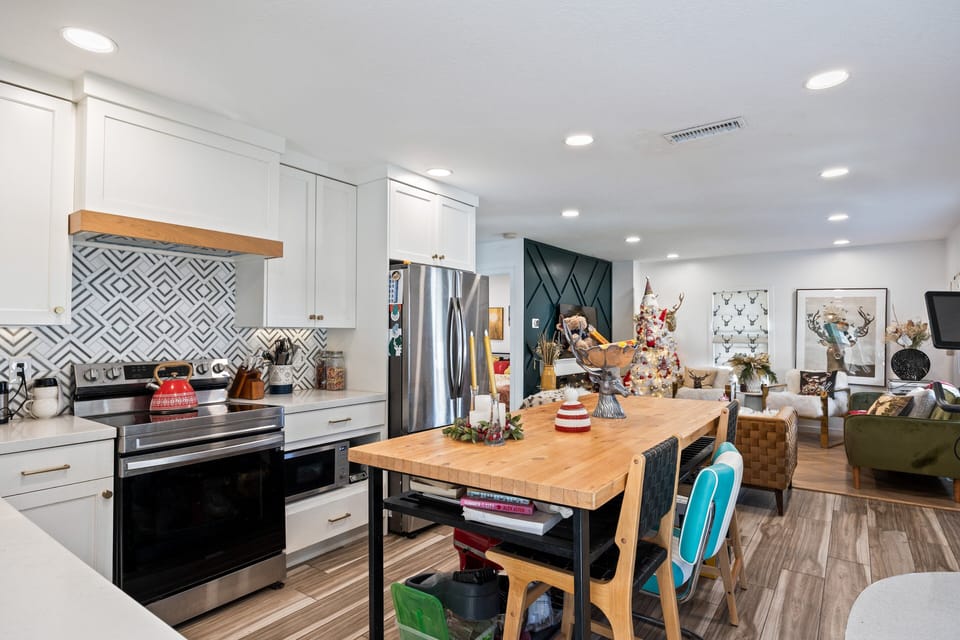 Open-concept kitchen and dining area with a spacious wood table—perfect for meals, gatherings, or game nights.