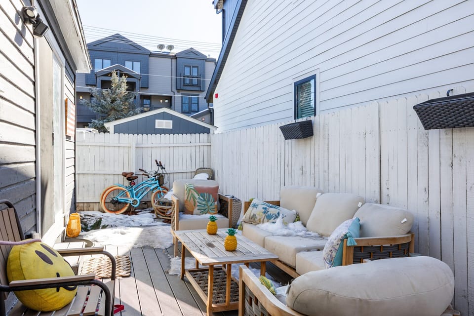Private fenced patio with outdoor seating—perfect for enjoying fresh air and morning coffee.