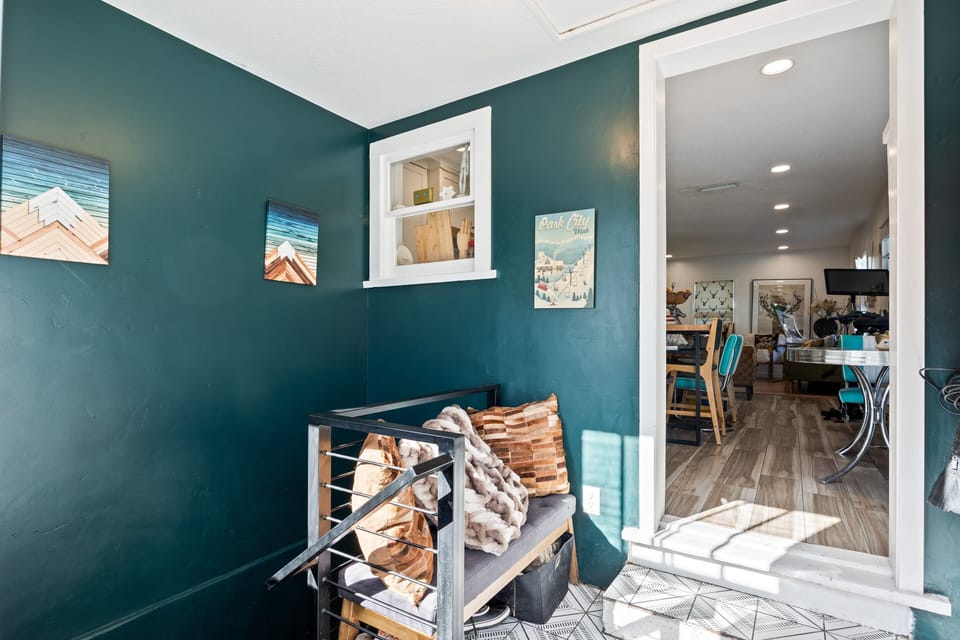 Stylish entry area with accent wall and convenient storage—setting the tone for the home's modern design.