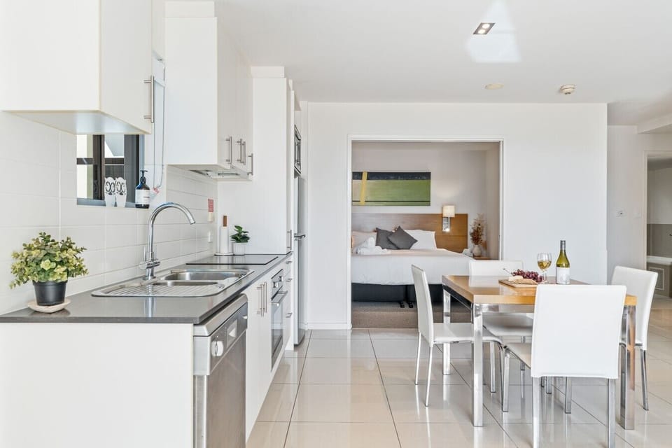 A clean, well-equipped kitchen flows straight into the dining area — cook, eat, and relax all in one easy open-plan space.